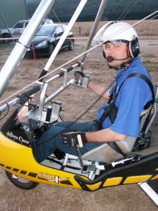 Dave’s earlier trike used a hand lever for ground steering (shown here in his left hand). This was found to be unsuitable and dangerous when it was moderately windy, therefore the sip/puff systems was developed. Refer to the Edge X – 582 Adaptation Report (link provided below) for further information.